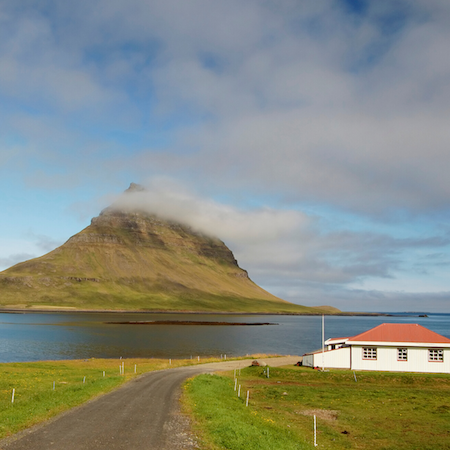 A house with a beautiful view of Kirkjufell mountain on Snæfellsnes Peninsula in Iceland.