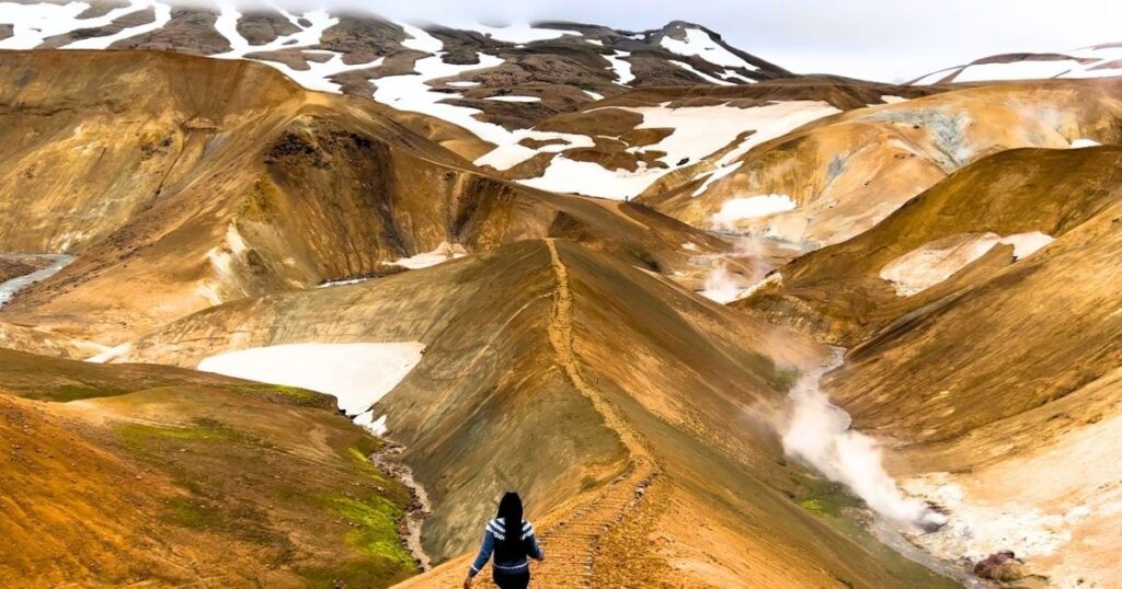 Jewells Chambers walking through the colorful geothermal landscape of Kerlingarfjöll in the Icelandic Highlands